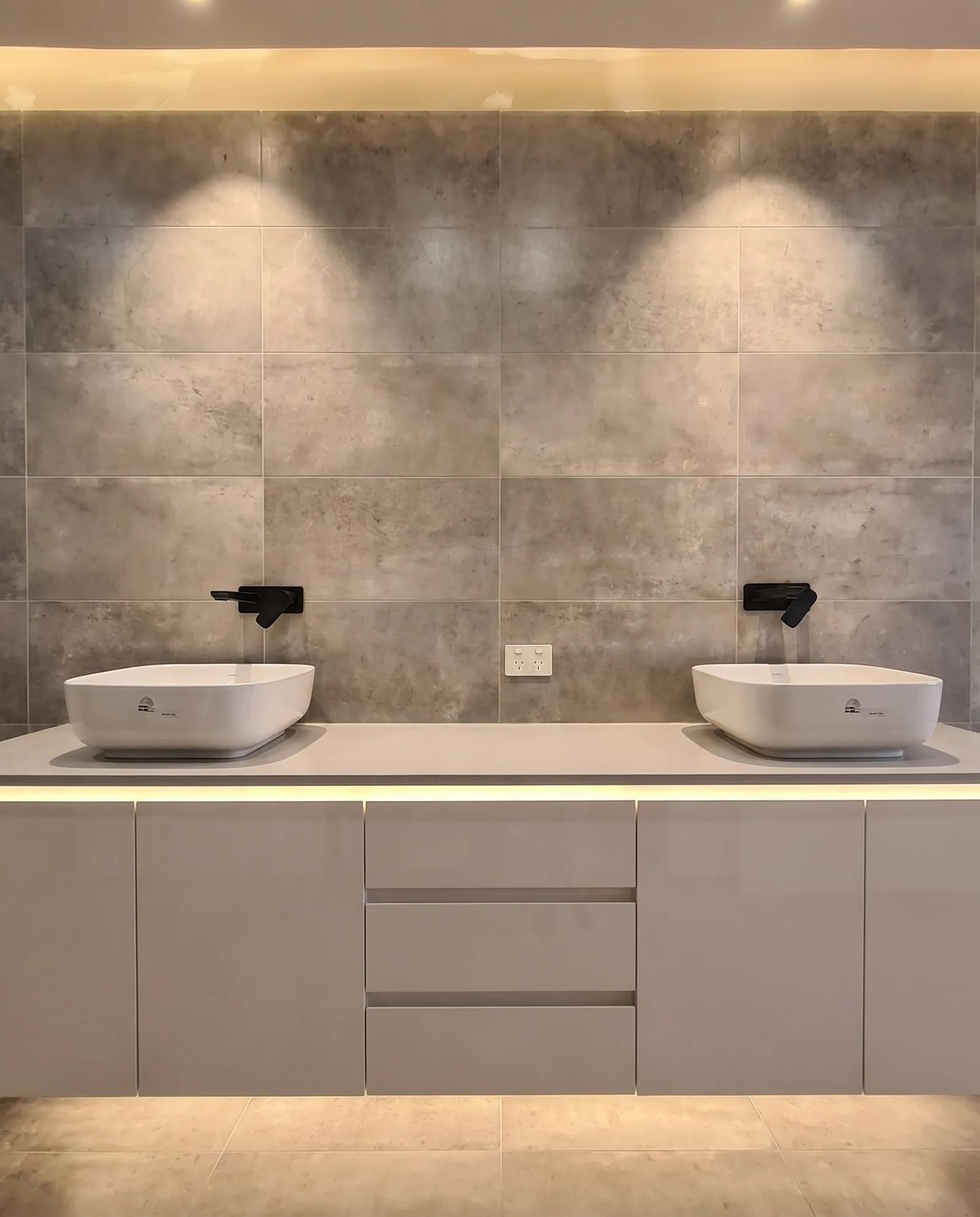 Dual-basin grey tile bathroom