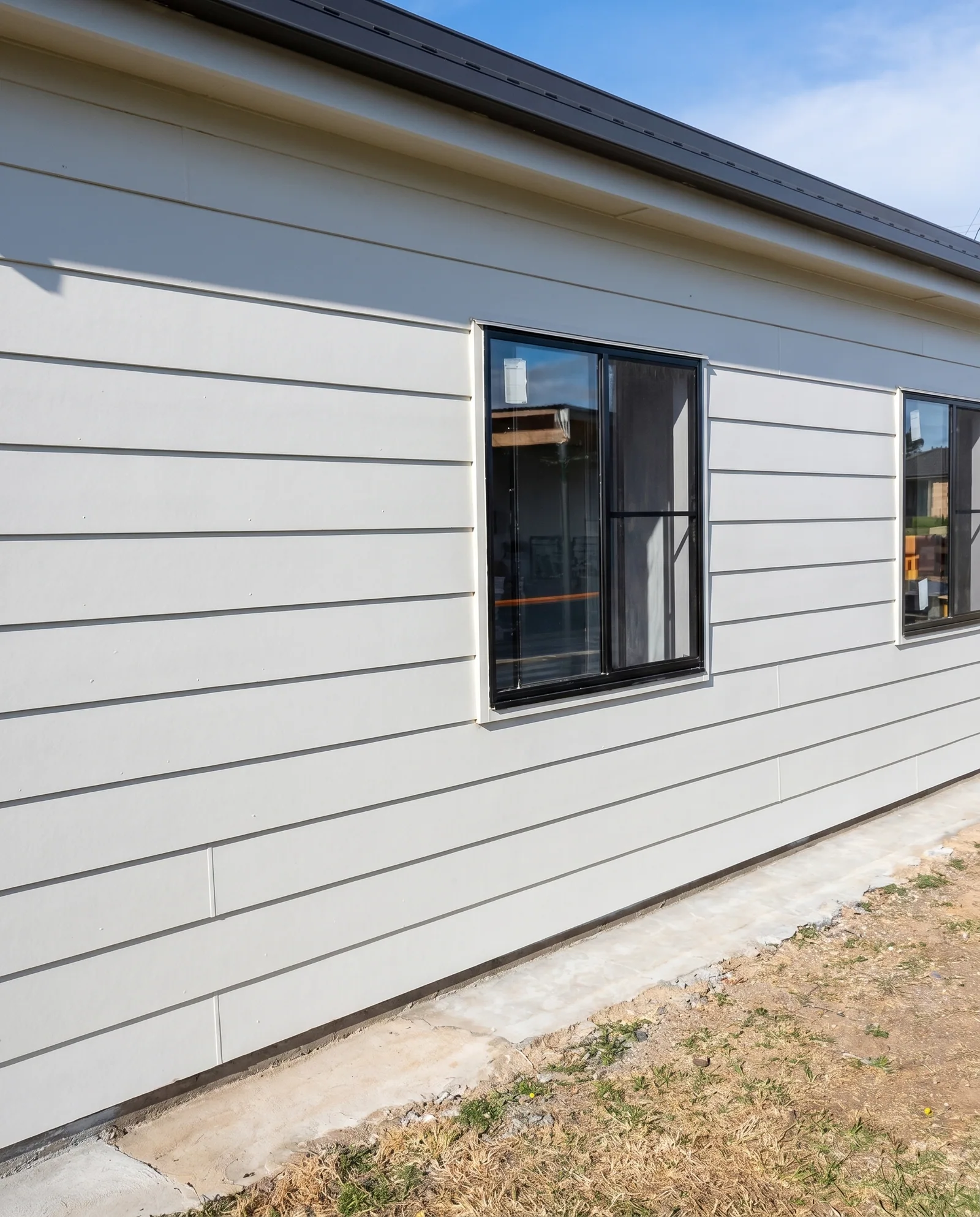 Weatherboard extension with black windows